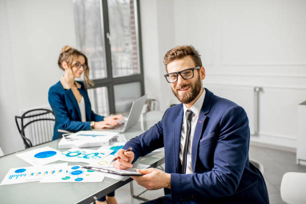 istock Businessman portrait working with assistant at the office 898074126