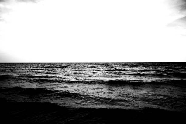 Beautiful black and white color on soft wave water sea and cloudy sky.