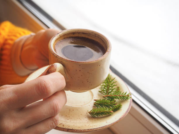 istock Winter coffee. Cup of black coffee at the window. 898080040