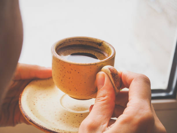 istock Winter coffee. Cup of black coffee at the window. 898080234