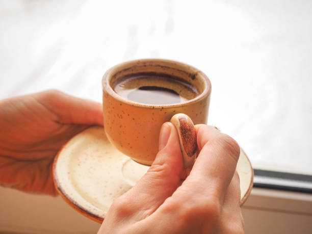 istock Winter coffee. Cup of black coffee at the window. 898080278