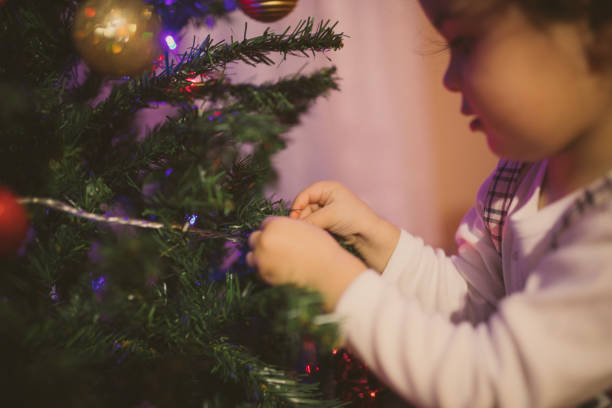istock Cute little girl decorating Christmas Tree 898092356