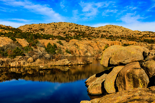 Rugged landscape meets smooth water as it winds between the rock at Wichita Mountains National Wildlife Refuge, November 2017