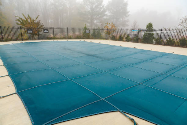 Pool Cover in Fog A Blue Vinyl Pool Cover in Fog covering stock pictures, royalty-free photos & images