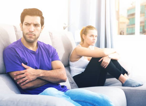 istock Guy on couch after discord with girlfriend 898137916