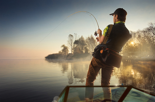 Fishing. Man fishing on a lake on boat