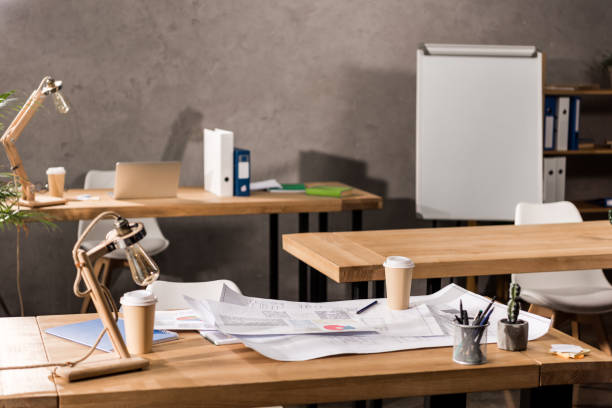istock working tables with blueprints, coffee and supplies 898141188