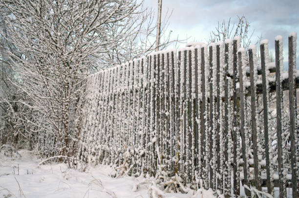 istock old snow-covered fence 898141324