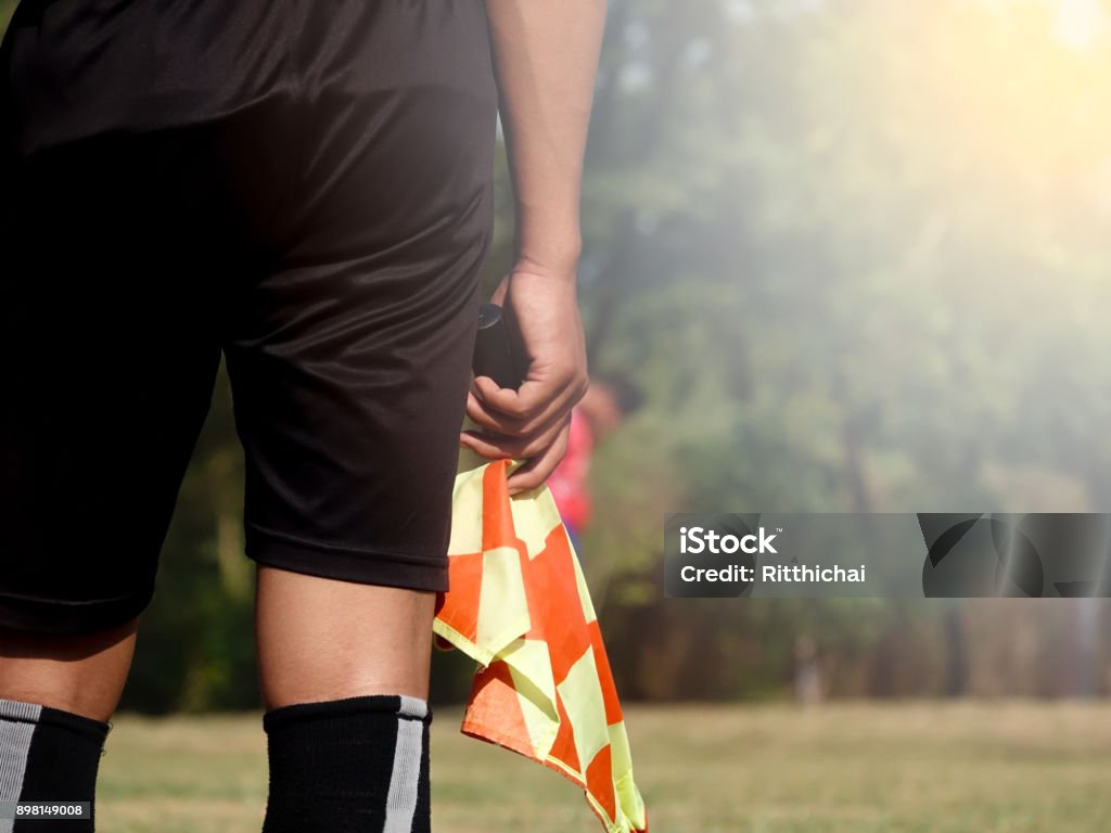 Assistant referee or Lineman of football or soccer holding flag Referee Stock Photo