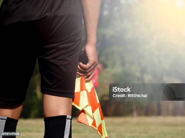 Assistant Referee Or Lineman Of Football Or Soccer Holding Flag Stock Photo - Download Image Now