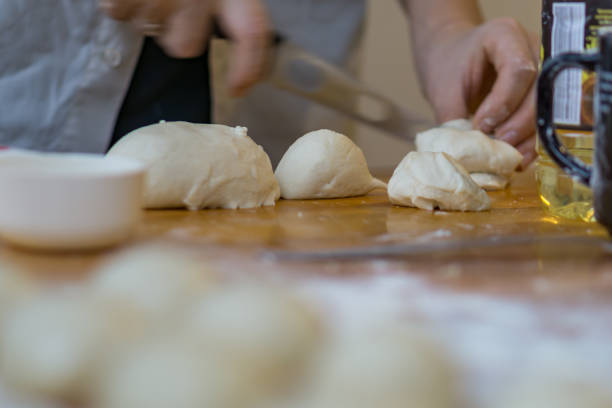 istock Closeup of ball ready dough on floured kitchen table. Defokus in the background. 898149708