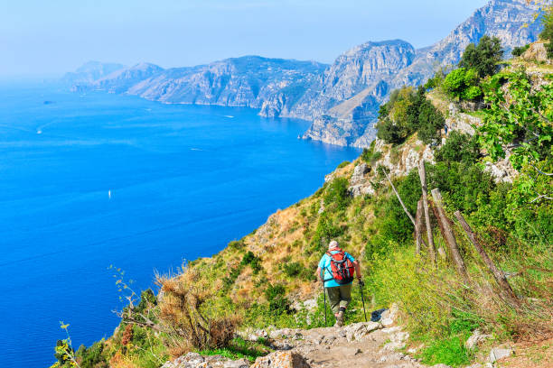 Backpacker with nordic walking at Path of Gods Backpacker with nordic walking at Path of Gods, Amalfi coast, Italy god stock pictures, royalty-free photos & images