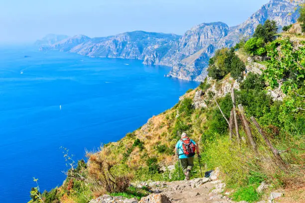 Backpacker with nordic walking at Path of Gods, Amalfi coast, Italy