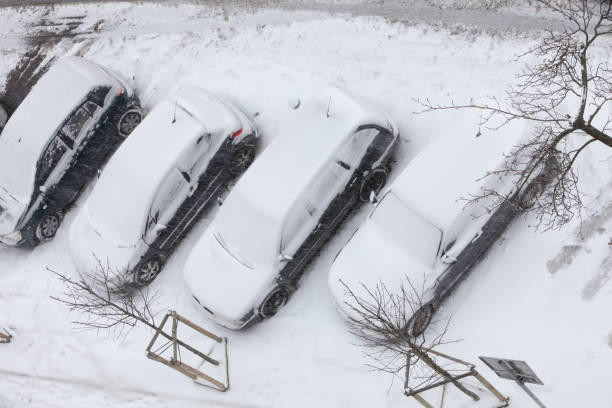 istock Parked cars covered in snow after blizzard top view 898164596
