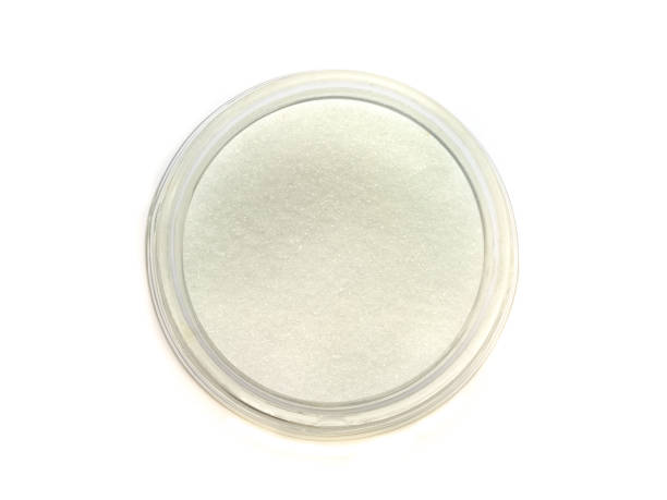 istock Sugar in a glass bottle top view on white background 898169372