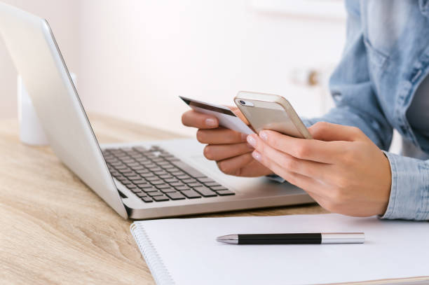 istock Hands holding credit card and using laptop. Online shopping 898172452