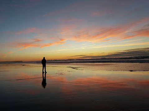 Man looking at beautiful sunset at the beach