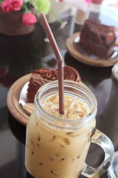 cup of ice coffee on wooden table.