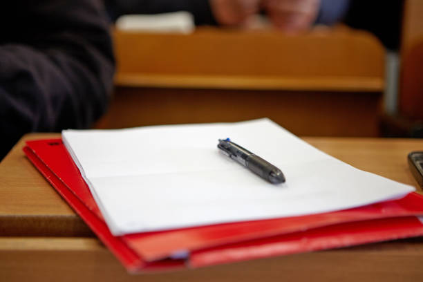 Pen on white paper on a desk.