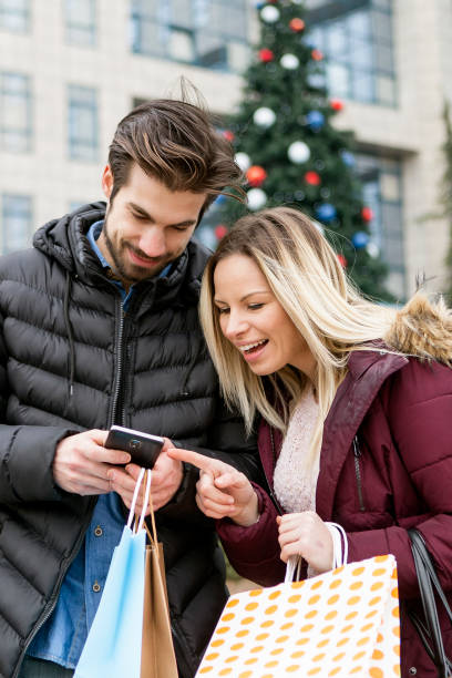 istock Young couple taking selfie in front of Christmas tree 898182468
