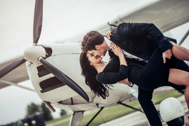 istock Couple near plane. 898185306