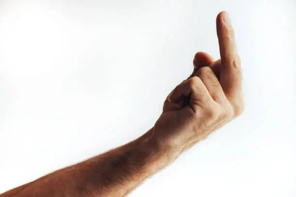 Hand holding middlefinger up for an obscene gesture