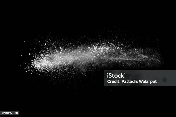 Freeze Motion Explosion Of White Dust On Black Background By Throwing Talcum Powder Out Of Hand Stopping The Movement Of White Powder On Dark Background Stock Photo - Download Image Now