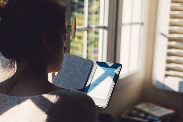 istock Woman at home reading a book 898200164