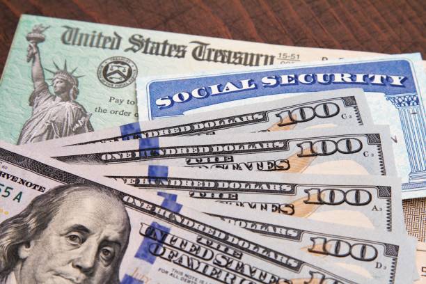 Money: closeup of USA currency with government treasury check and social security card stock photo