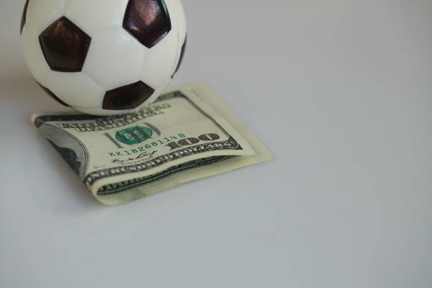 istock football ball and dollars contractual match bookmaker 898203764