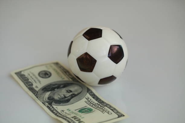 istock football ball and dollars contractual match bookmaker 898203782