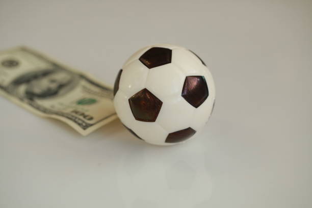 istock football ball and dollars contractual match bookmaker 898203786