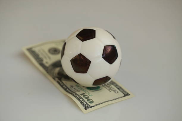 istock football ball and dollars contractual match bookmaker 898203788