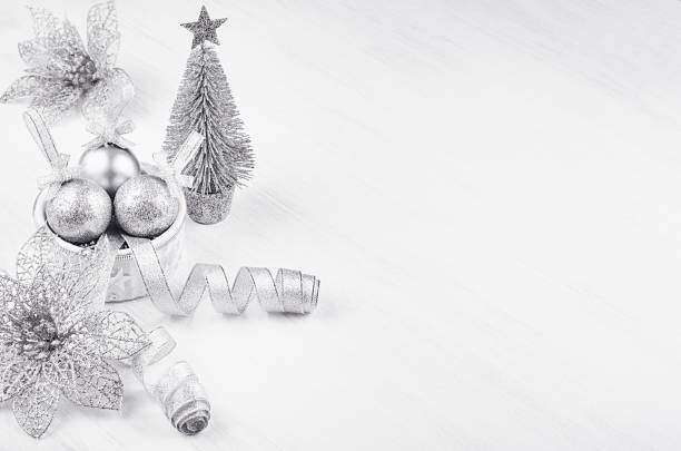 istock Christmas modern silvery decorations on white plaster, wood background, border. 898207880