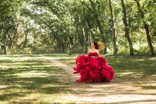 istock Princess with crown in cloudy red dress 898208532