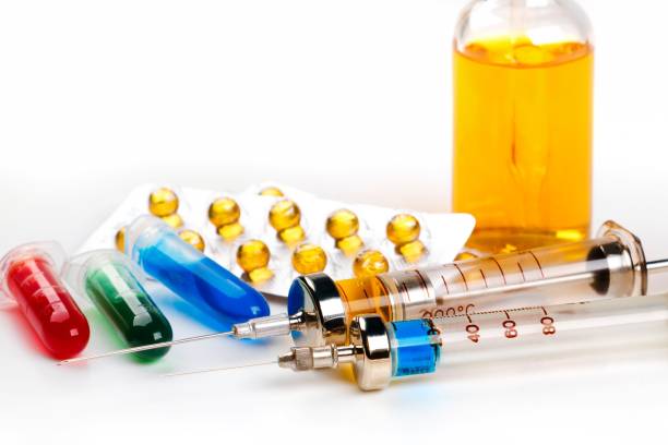 istock Syringes with medication, blister pack, vials and bottle with colored fluid on white background 898209828