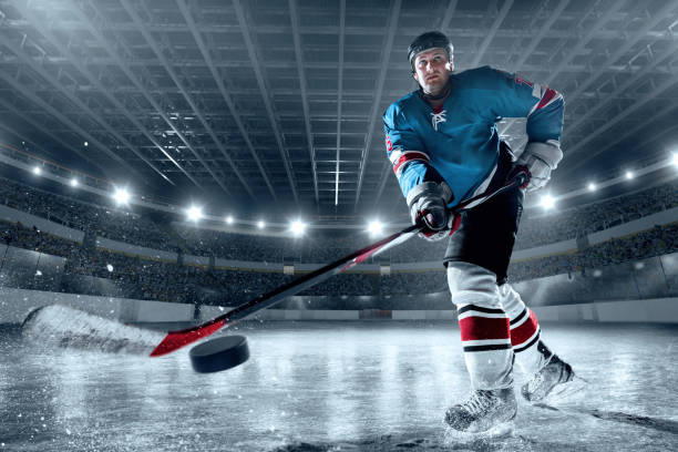 istock Ice hockey player on big professional ice arena 898211020