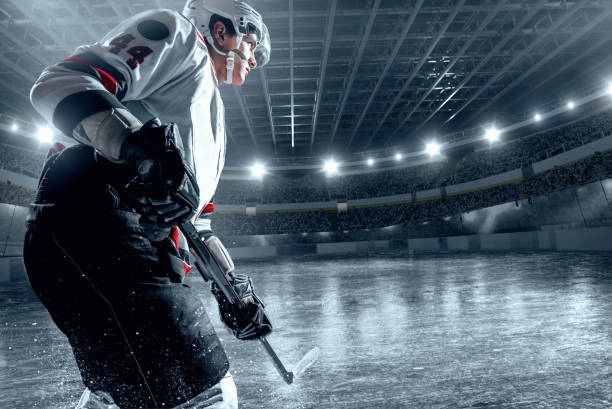 istock Ice hockey player on big professional ice arena 898211022
