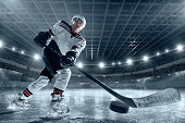 Ice hockey player on big professional ice arena