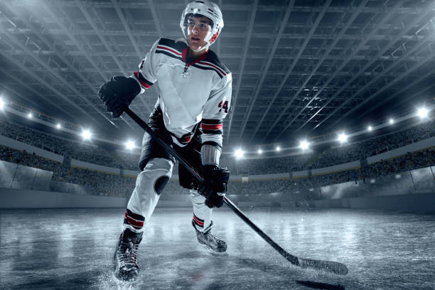 istock Ice hockey player on big professional ice arena 898211040