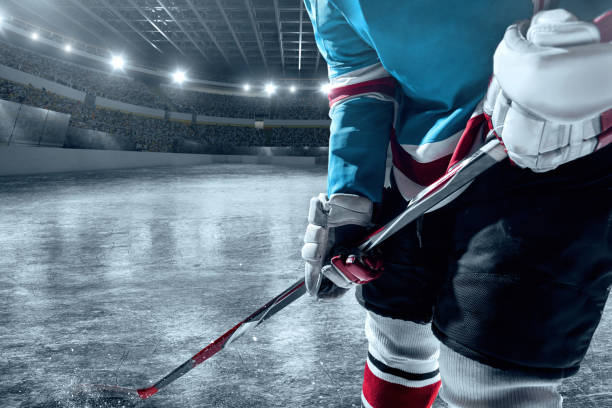 istock Ice hockey player on big professional ice arena 898211044