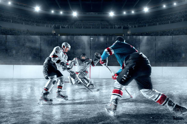 eishockey-spieler auf große professionelle eis-arena - ice hockey hockey puck playing shooting at goal stock-fotos und bilder