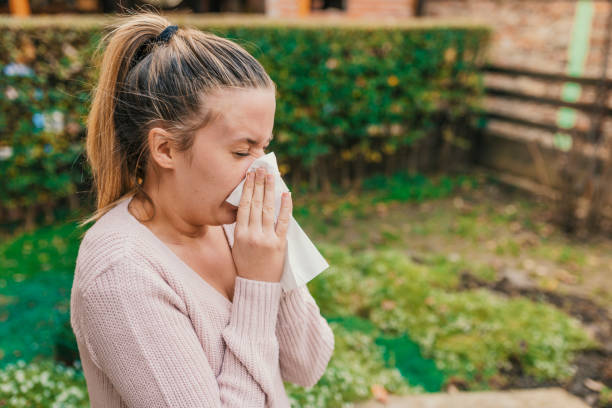 istock Woman blowing her nose into tissue 898219500