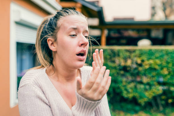 istock Young woman is having flu and she is sneezing. 898220872