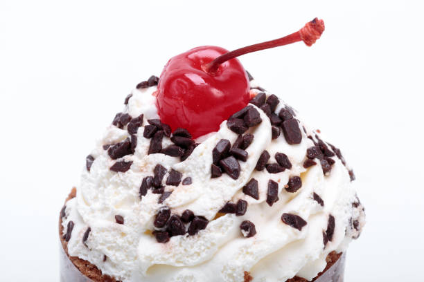 istock Black forest cake, topped with whipped cream and cherry isolated on white 898227588