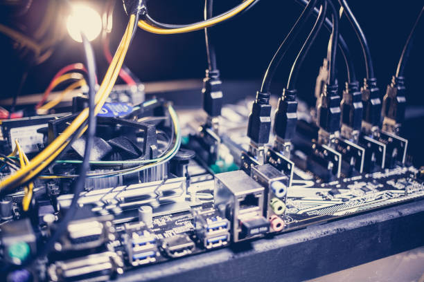 istock Cryptocurrency mining rig PCIe riser extenders plugged to motherboard. 898228940