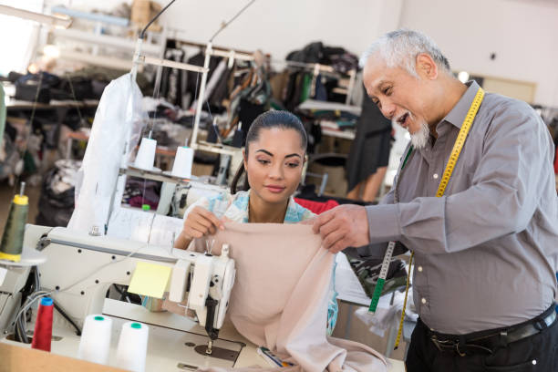 istock Senior tailor observing in textile factory 898230830