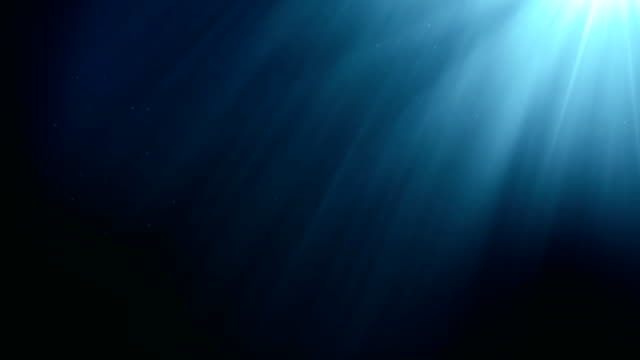 Underwater seamless scene with air bubbles floating up and sun shining through the water.
