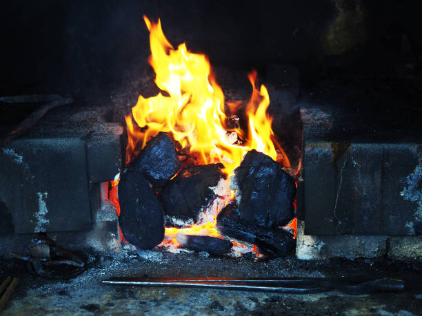 istock Burning fire in the blacksmith's forge, hot forging tongs, horseshoes, blanks, hook 898232202