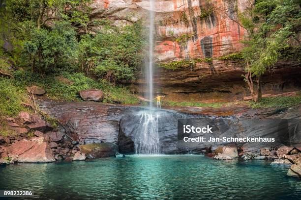 A Man Behind The Salto Suizo The Highest Waterfall Of Paraguay Near The Colonia Independencia And Vallarrica Stock Photo - Download Image Now